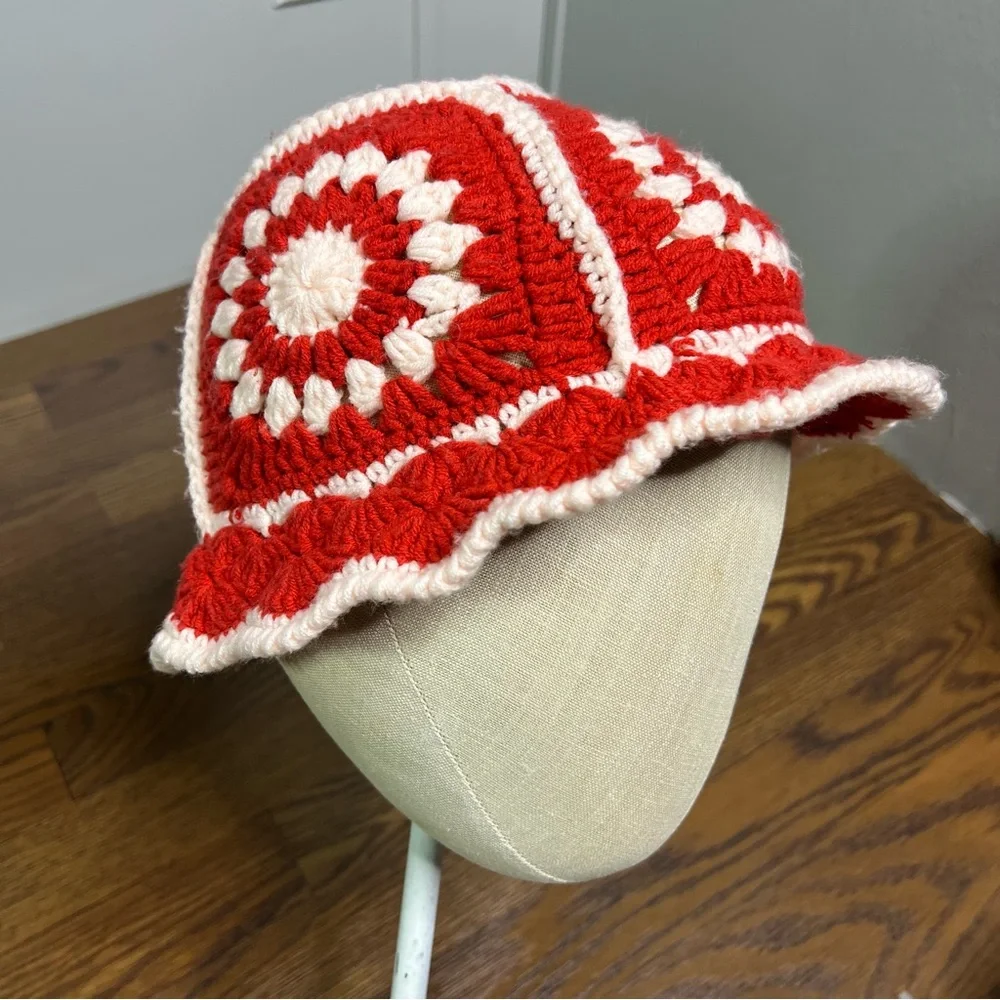Handmade crochet bucket hat with a retro red and white sunburst pattern